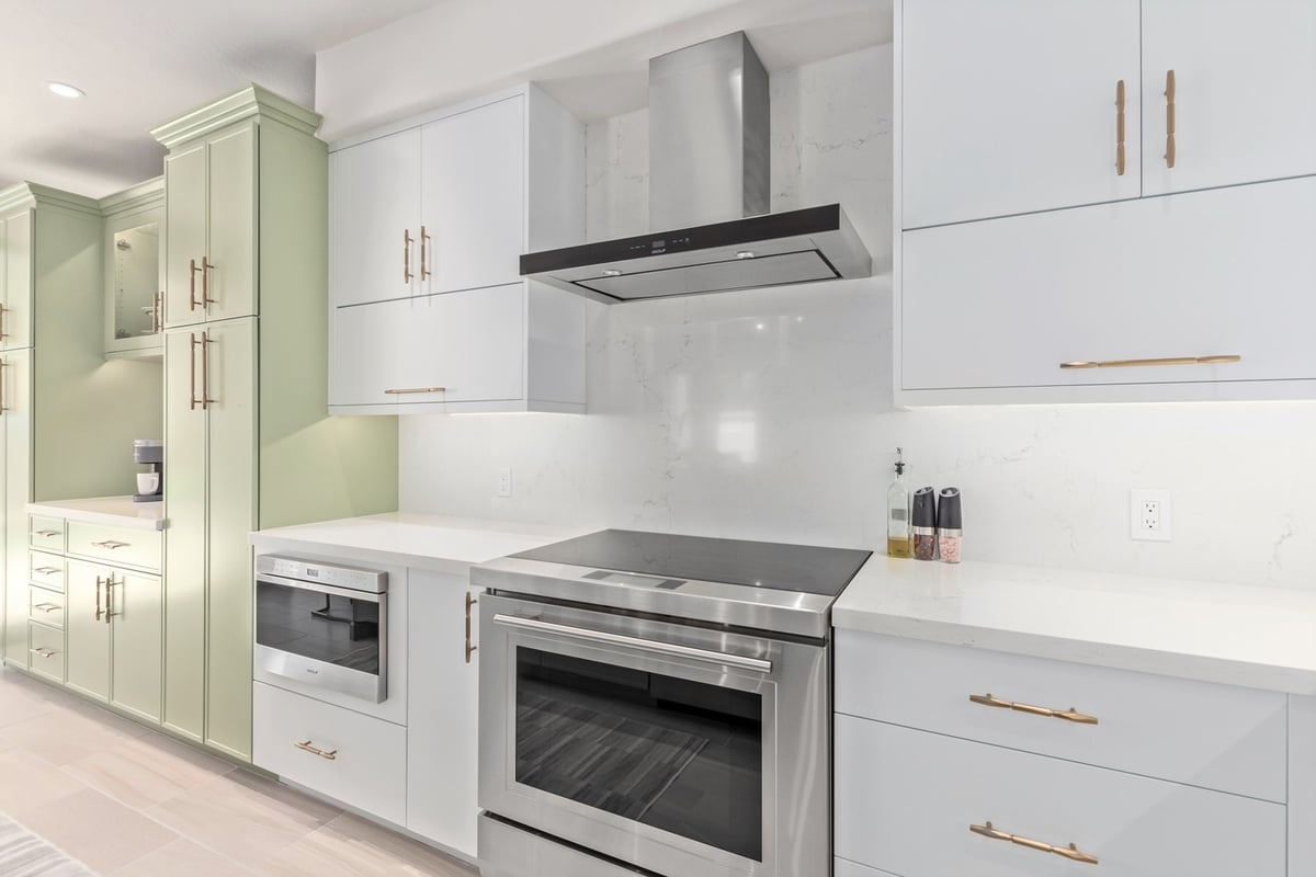 Contemporary kitchen with integrated appliances and clean white cabinetry in Arizona.
