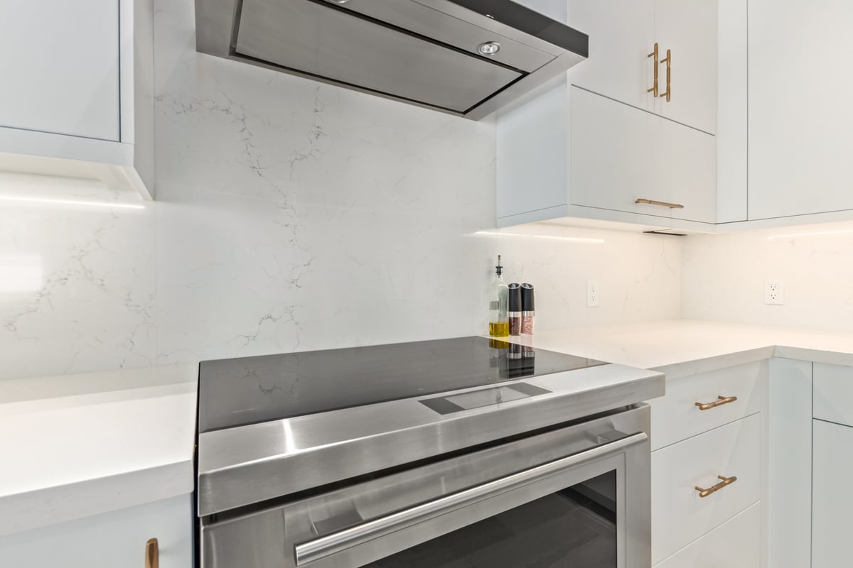 Modern kitchen cooktop and range hood in a Scottsdale custom home by Kitchens by Good Guys.