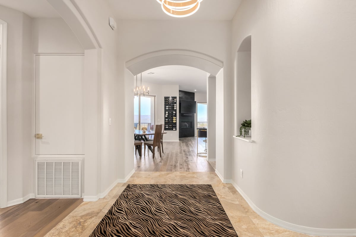 Arched hallway entry leading to dining area in a custom Phoenix home by Kitchens by Good Guys.