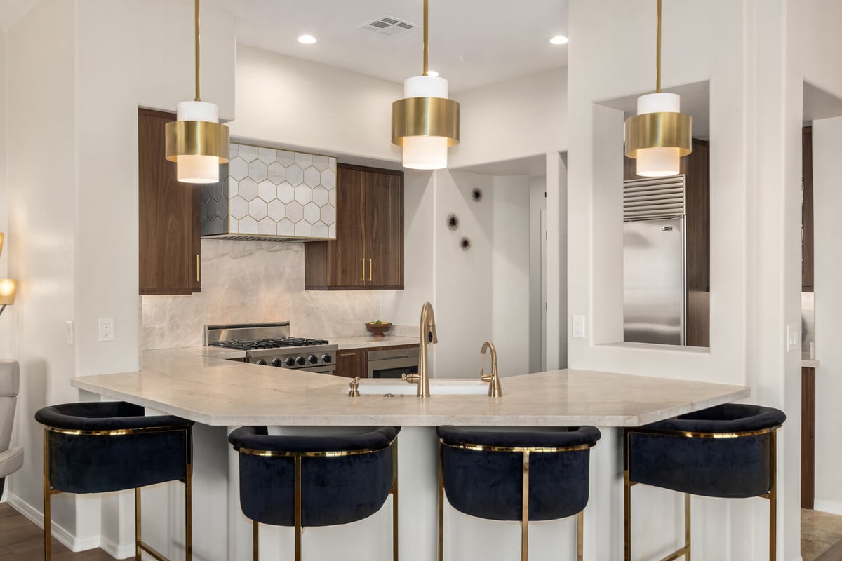Close-up of modern kitchen island and pendant lights in a custom Paradise Valley home by Kitchens by Good Guys.