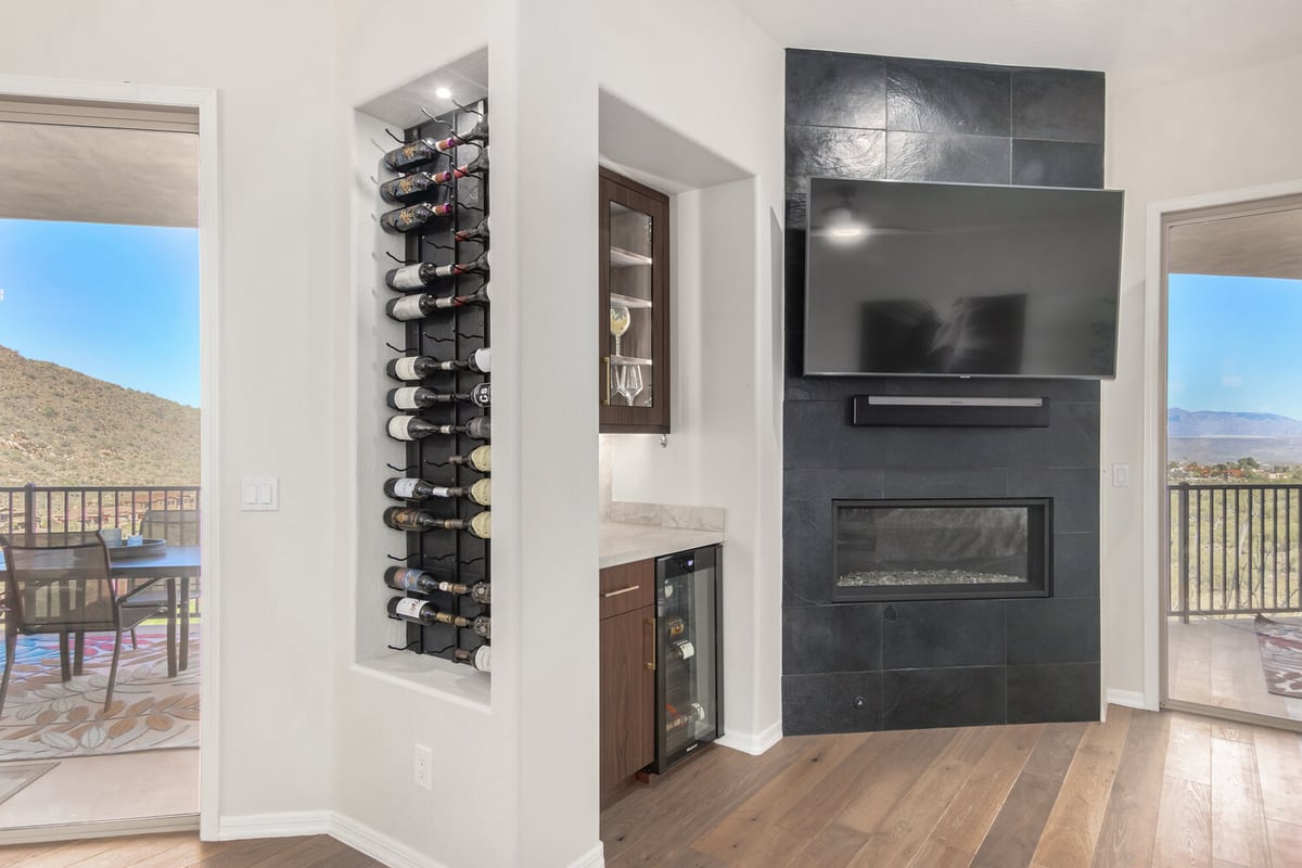 Custom home fireplace and wet bar in modern living room by Kitchens by Good Guys in Scottsdale, AZ.
