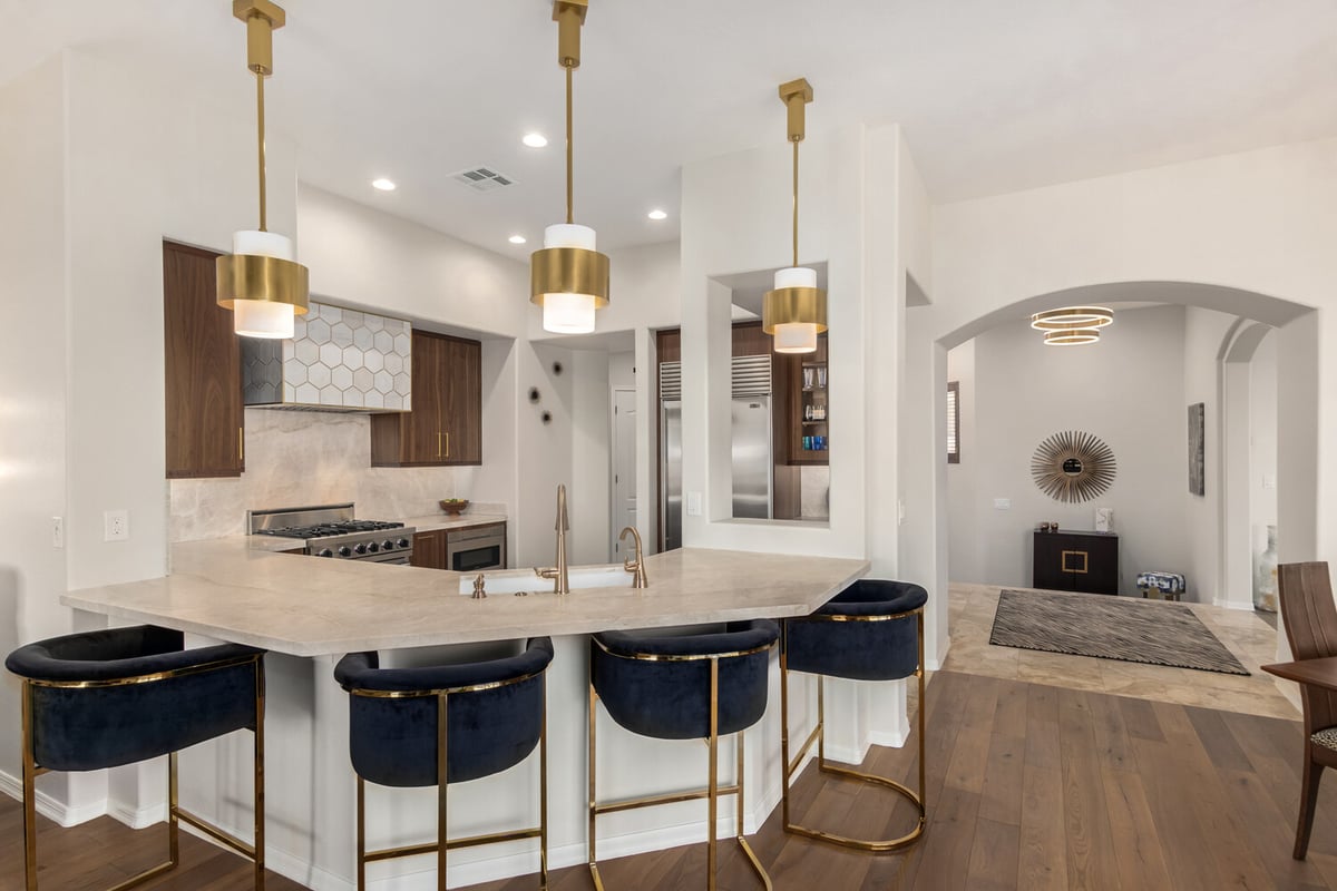 Custom kitchen island with pendant lighting and modern bar stools by Kitchens by Good Guys in Scottsdale, AZ.