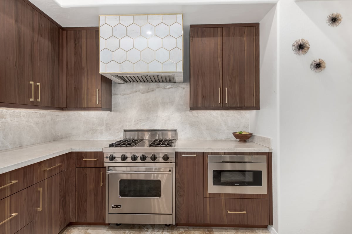 Detailed kitchen view with Viking gas range and custom backsplash in a Scottsdale home by Kitchens by Good Guys.