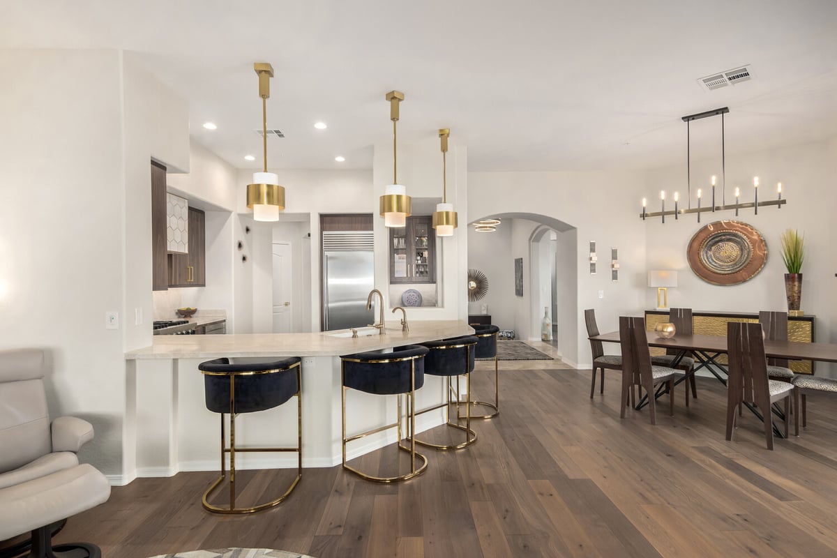 Luxury home interior with elegant pendant lighting and dining room setup by Kitchens by Good Guys in Mesa, AZ.