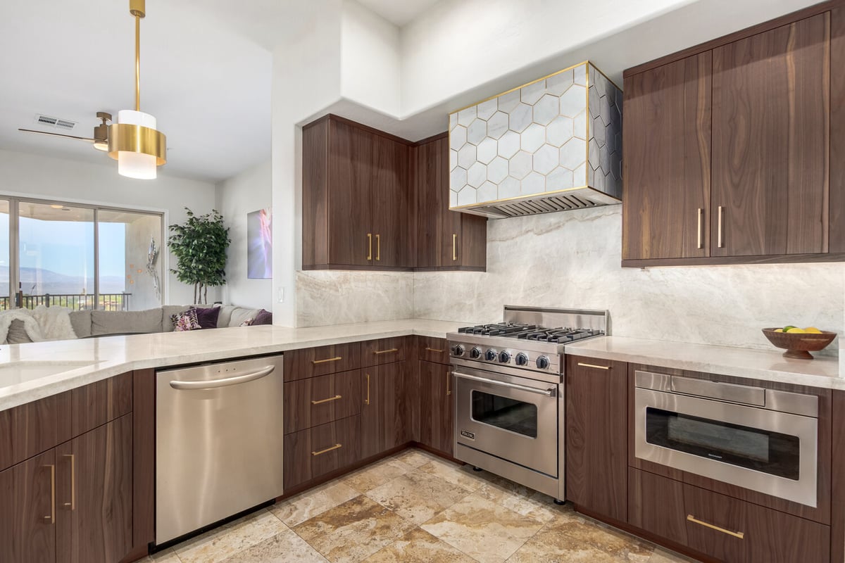 Luxury kitchen remodel featuring walnut cabinetry and modern backsplash by Kitchens by Good Guys in Mesa, AZ.