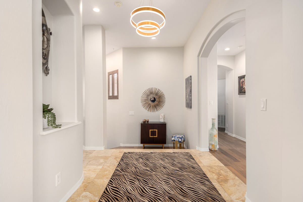 Modern hallway with arched entries and accent lighting in a Mesa custom home by Kitchens by Good Guys.