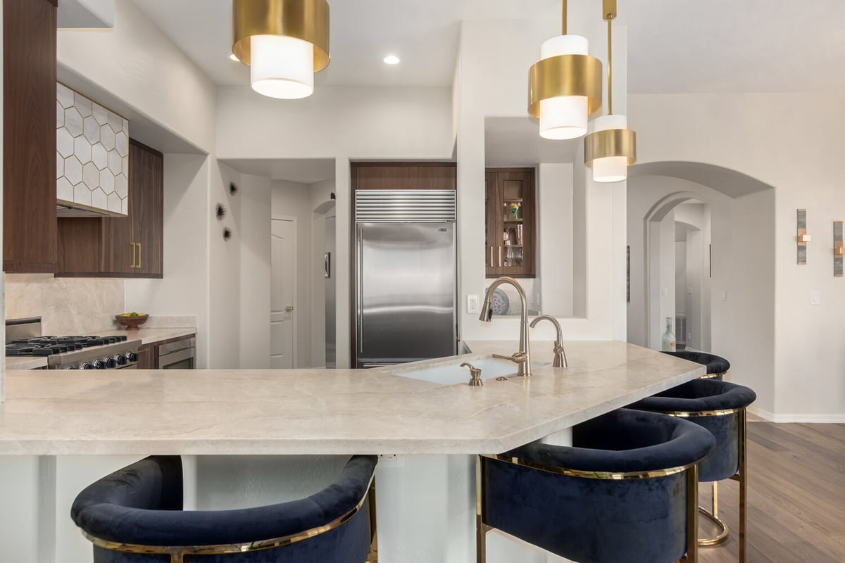 Upscale kitchen island with gold fixtures and quartz countertop by Kitchens by Good Guys in Paradise Valley, AZ.