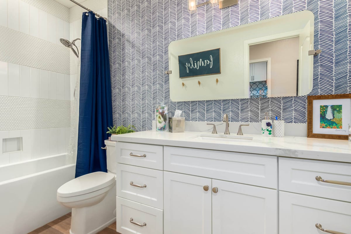 Scottsdale custom bathroom with blue shower curtain and white vanity by Kitchens by Good Guys