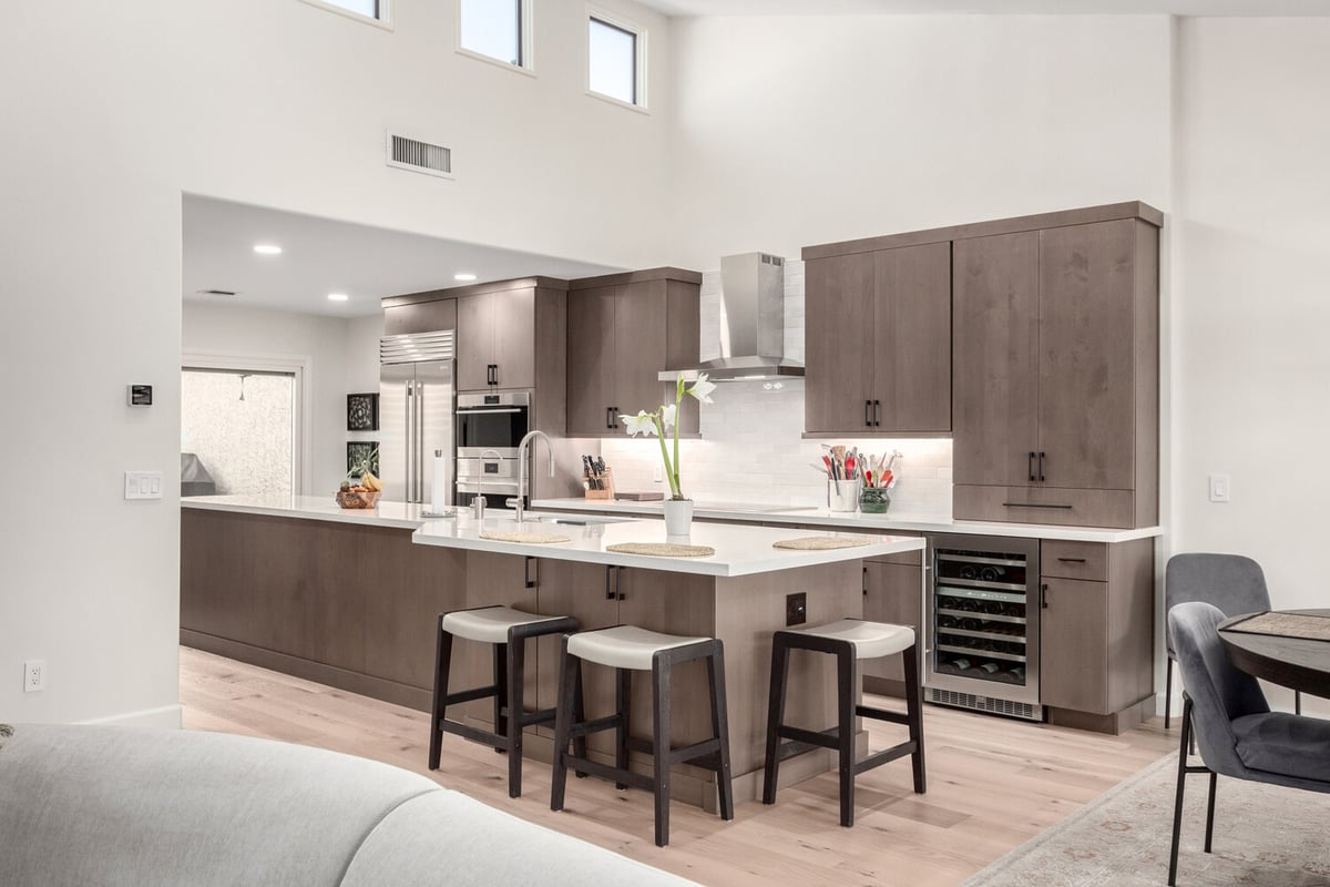 Sleek gray kitchen with waterfall island by Kitchens by Good Guys in Paradise Valley, AZ
