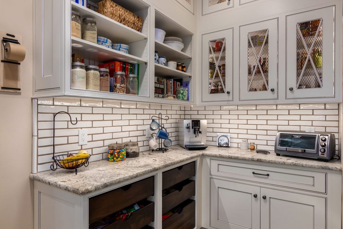 Organized pantry with stone counters by Kitchens by Good Guys in Paradise Valley