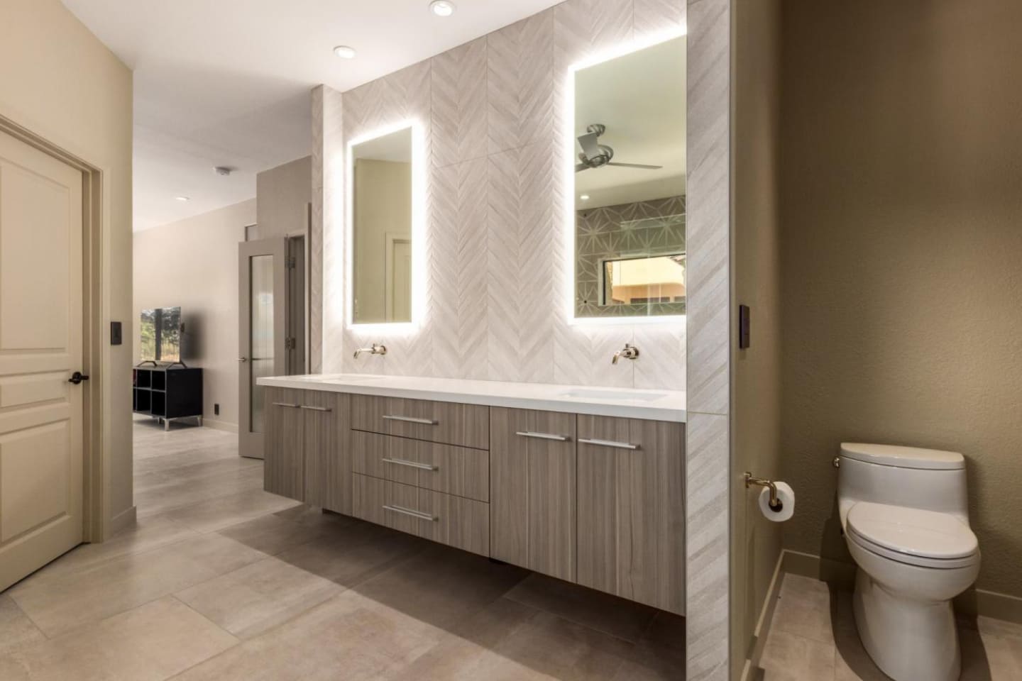 Modern bathroom in Scottsdale, AZ with floating vanity, backlit mirrors, and tile walls, designed by Kitchens by Good Guys Modern bathroom in Scottsdale, AZ with floating vanity, backlit mirrors, and tile walls, designed by Kitchens by Good Guys