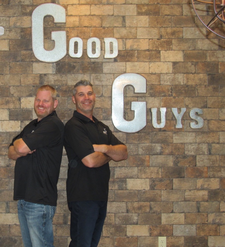 Leadership team of Kitchens by Good Guys smiling proudly at their Phoenix, AZ showroom