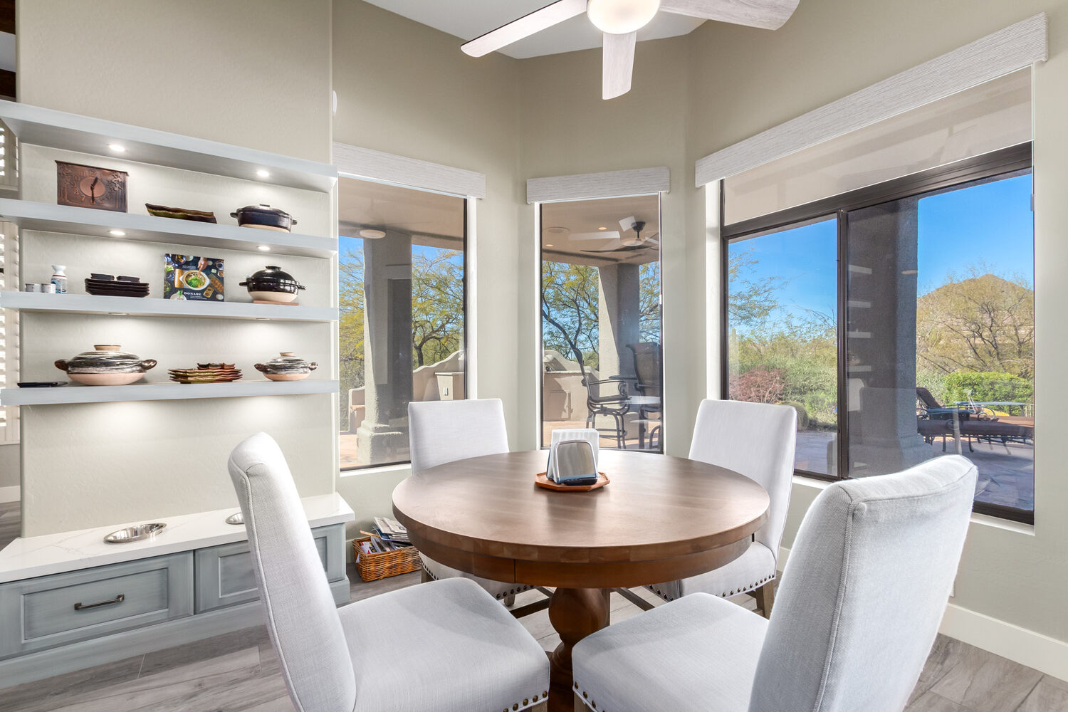 Round wood dining table with scenic desert views in Phoenix, AZ custom home by Kitchens by Good Guys. Round wood dining table with scenic desert views in Phoenix, AZ custom home by Kitchens by Good Guys.