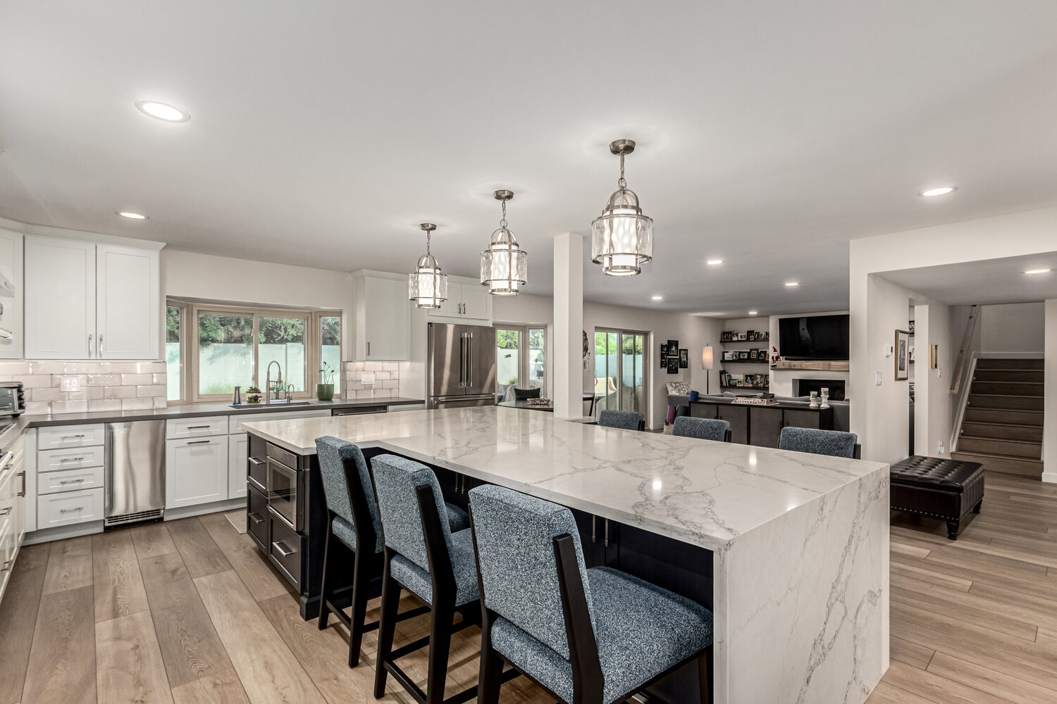 Custom kitchen featuring waterfall island and wood flooring in Scottsdale by Kitchens by Good Guys.