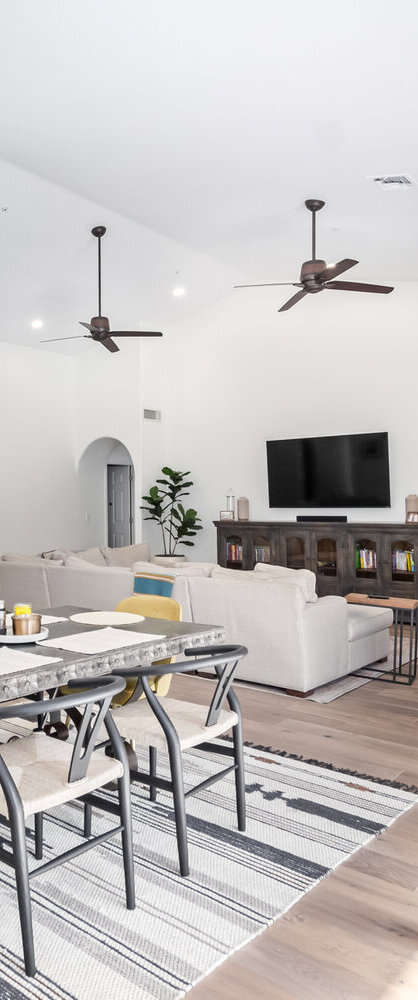Open-concept dining and living space with natural light in a Scottsdale custom home by Kitchens by Good Guys