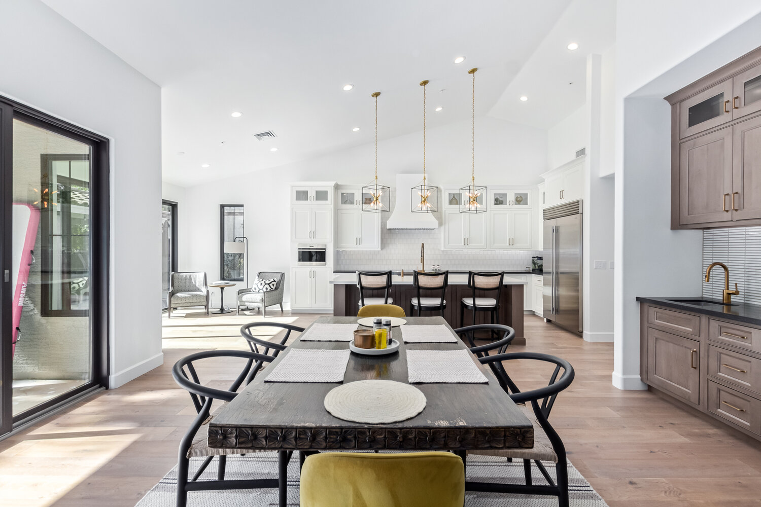 Spacious layout featuring open kitchen, dining, and lounge area in Scottsdale custom home by Kitchens by Good Guys. Spacious layout featuring open kitchen, dining, and lounge area in Scottsdale custom home by Kitchens by Good Guys.