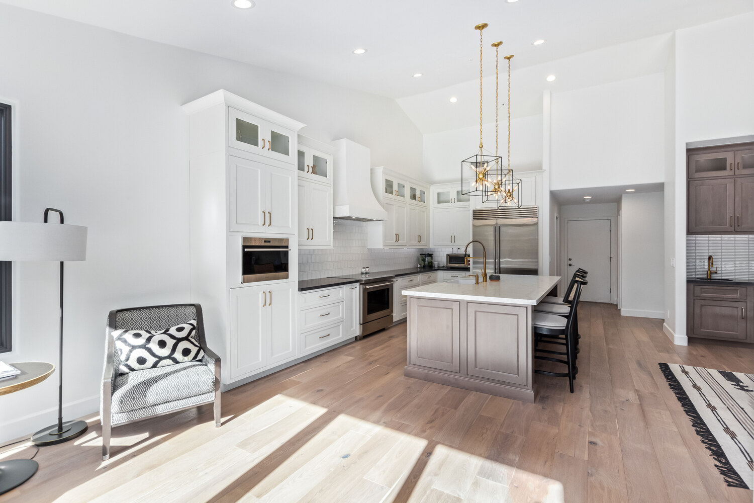 White custom kitchen with pendant lighting and island seating in Scottsdale home by Kitchens by Good Guys. White custom kitchen with pendant lighting and island seating in Scottsdale home by Kitchens by Good Guys.