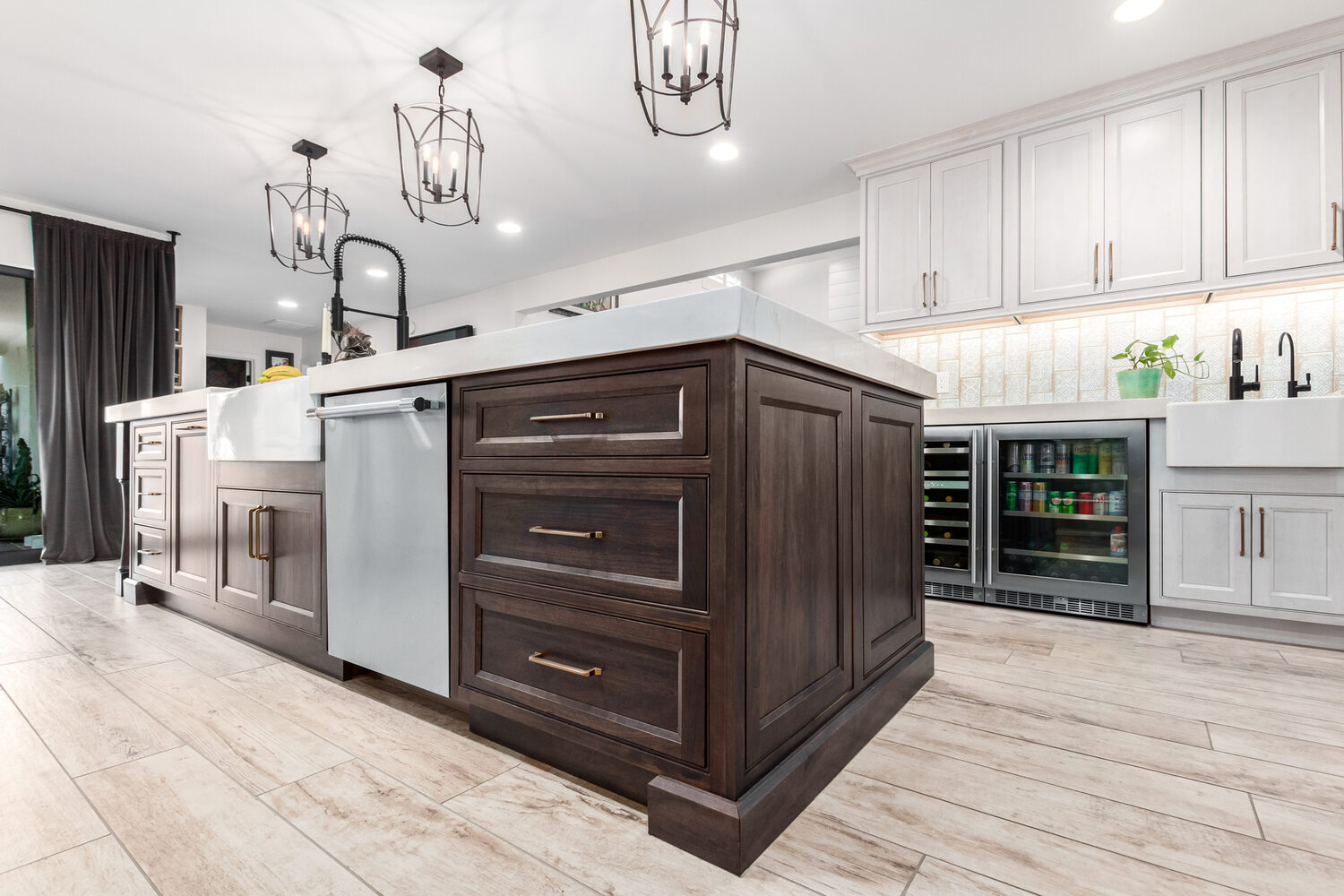 Angled view of two-tone kitchen island and bar stools in Paradise Valley custom home by Kitchens by Good Guys