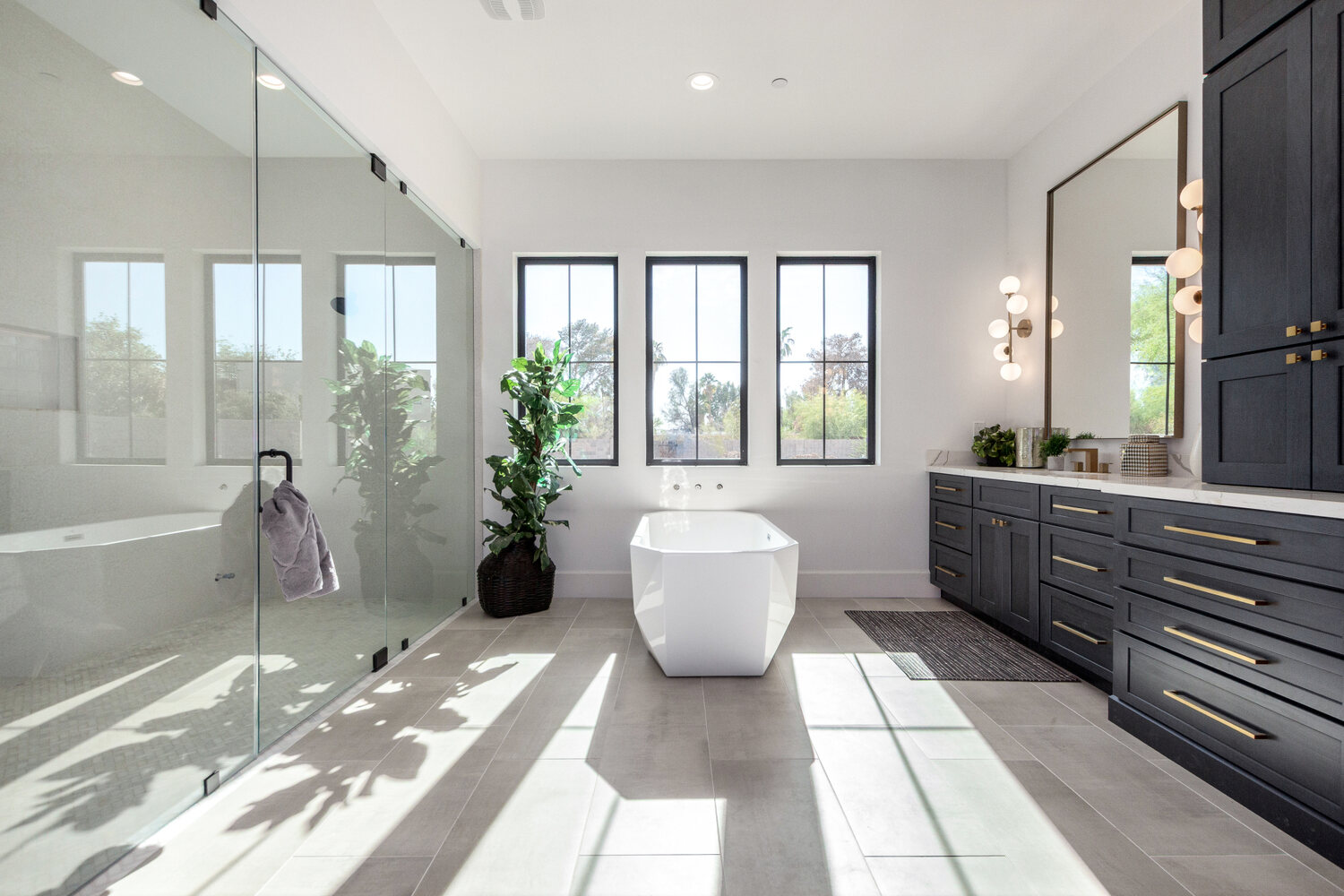 Spacious custom bathroom in Scottsdale with freestanding tub and floor-to-ceiling windows by Kitchens by Good Guys.