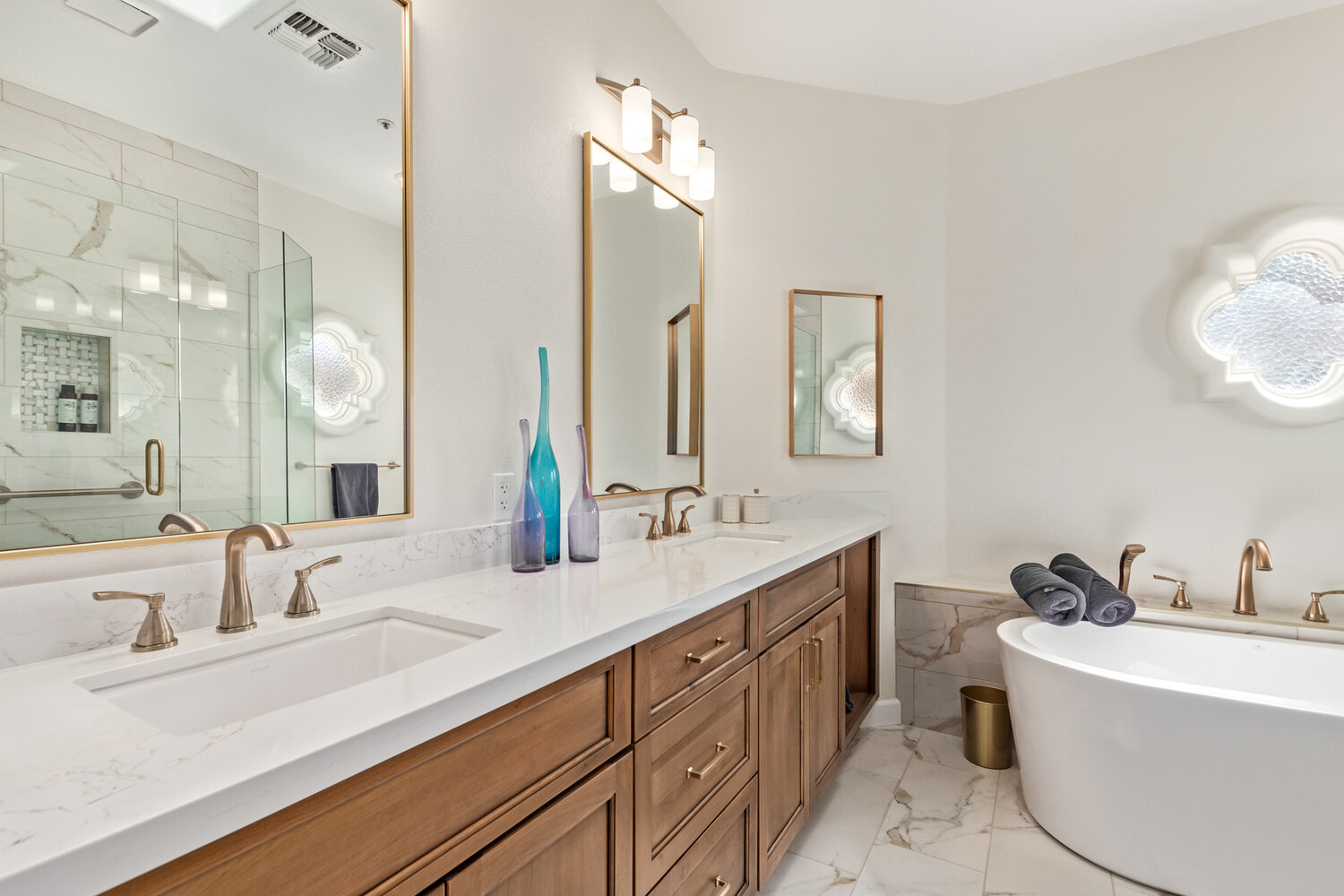 Elegant bathroom remodel with bronze fixtures by Kitchens by Good Guys in Paradise Valley