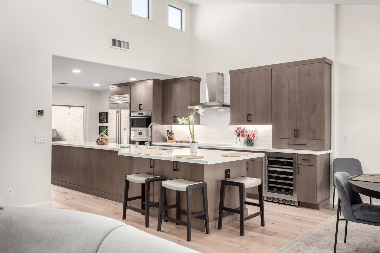 Sleek gray kitchen with waterfall island by Kitchens by Good Guys in Paradise Valley, AZ